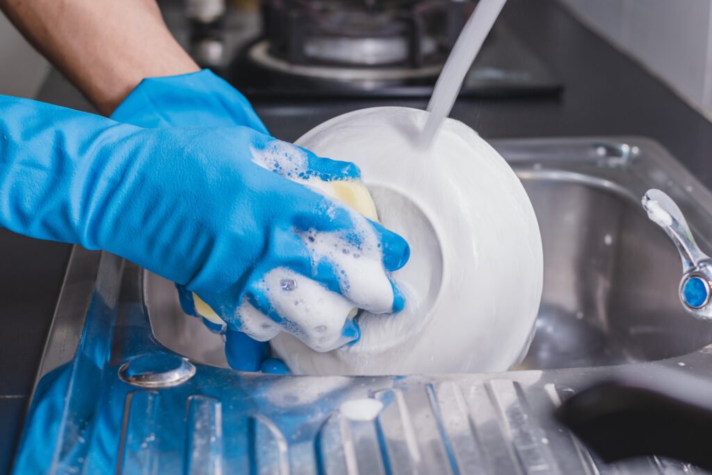 Washing the cup with a dish washing liquid.